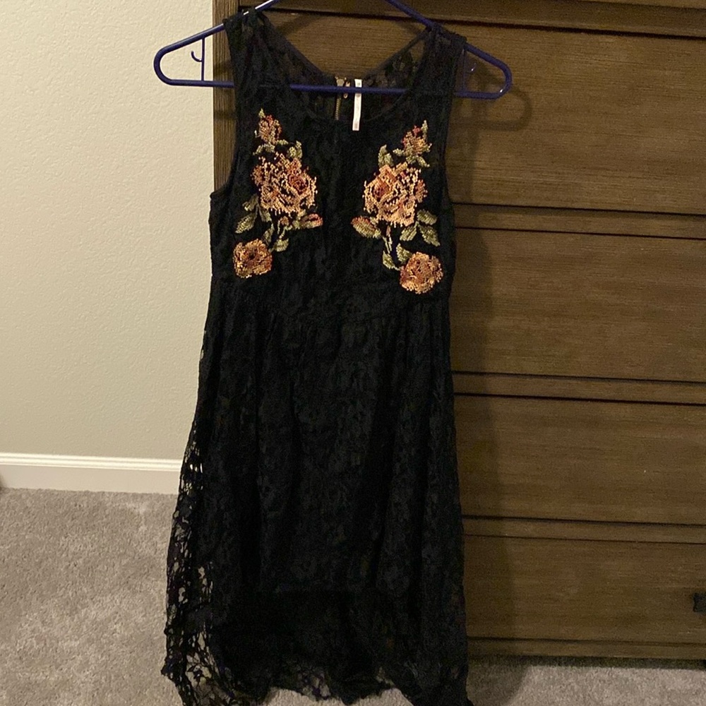 Free People high low black dress with embroidered flowers on front and back.